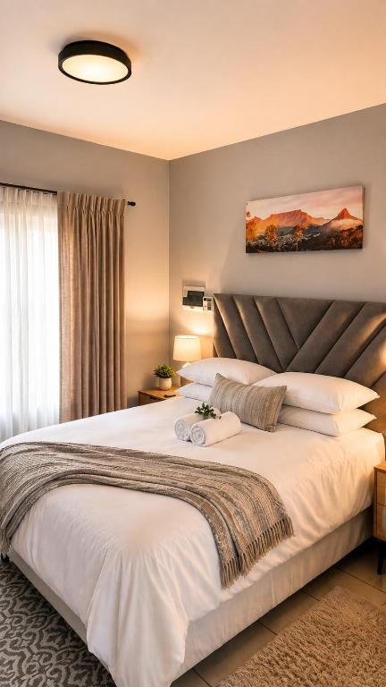 a bedroom with a large white bed in a room at The Prestige Studio in Bloemfontein