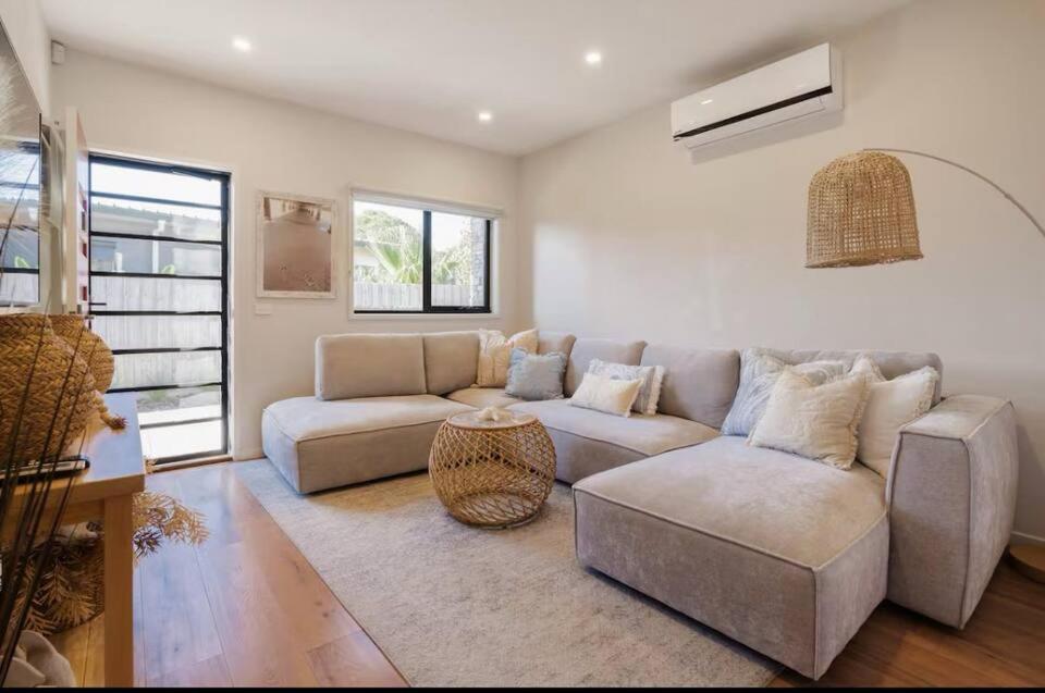 a living room with a couch and a table at Seaside Luxe at Vila Morava in Rosebud