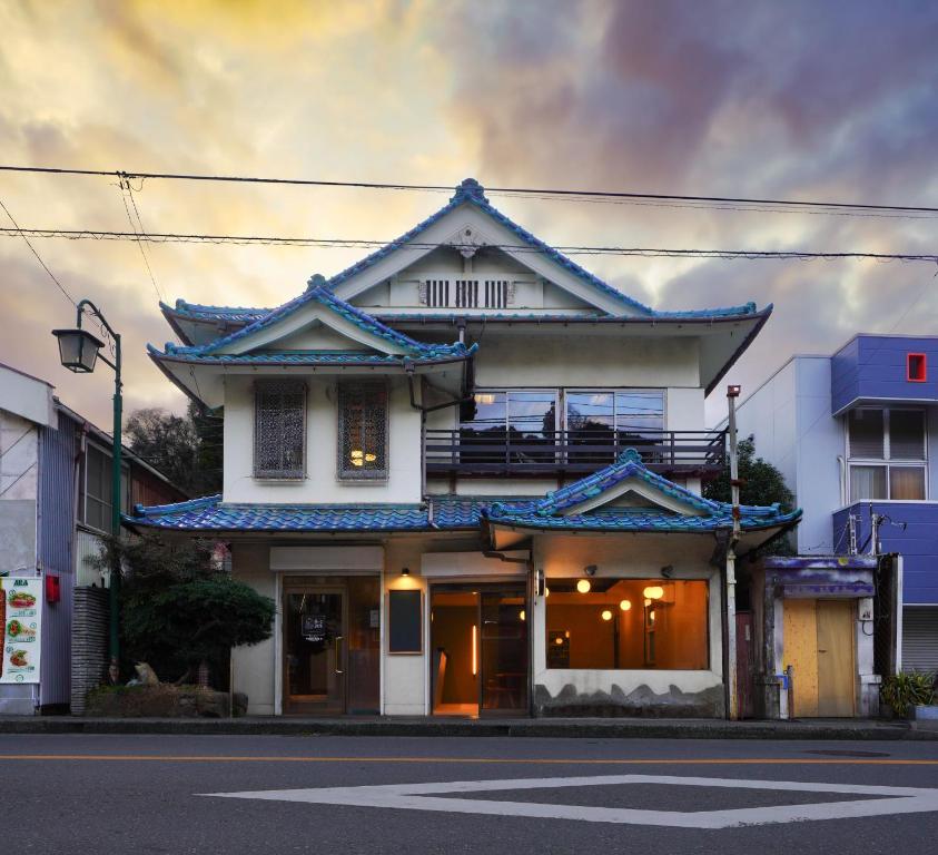 a building with an asian influence on a street at Wonderlust Inn in Kamakura