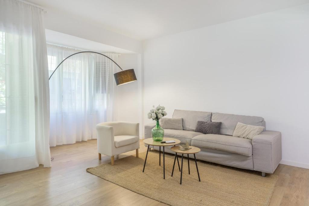 a living room with a couch and a table and a chair at Myholidayshome in Palamós