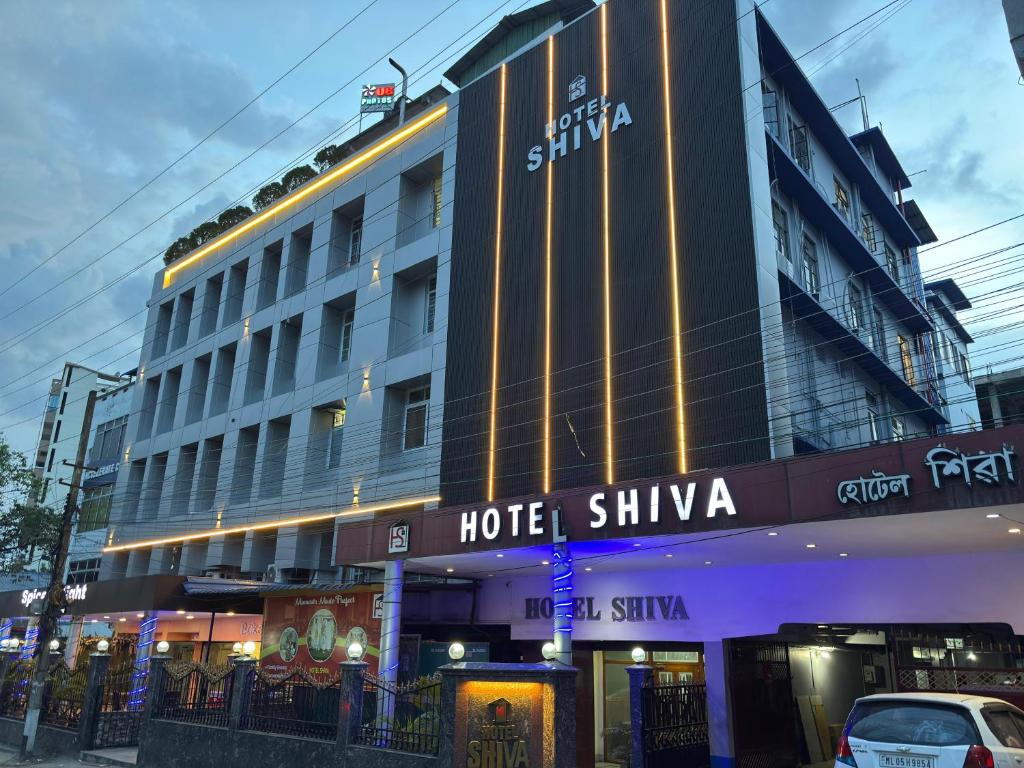 a hotel building with a car parked in front of it at HOTEL SHIVA in Guwahati