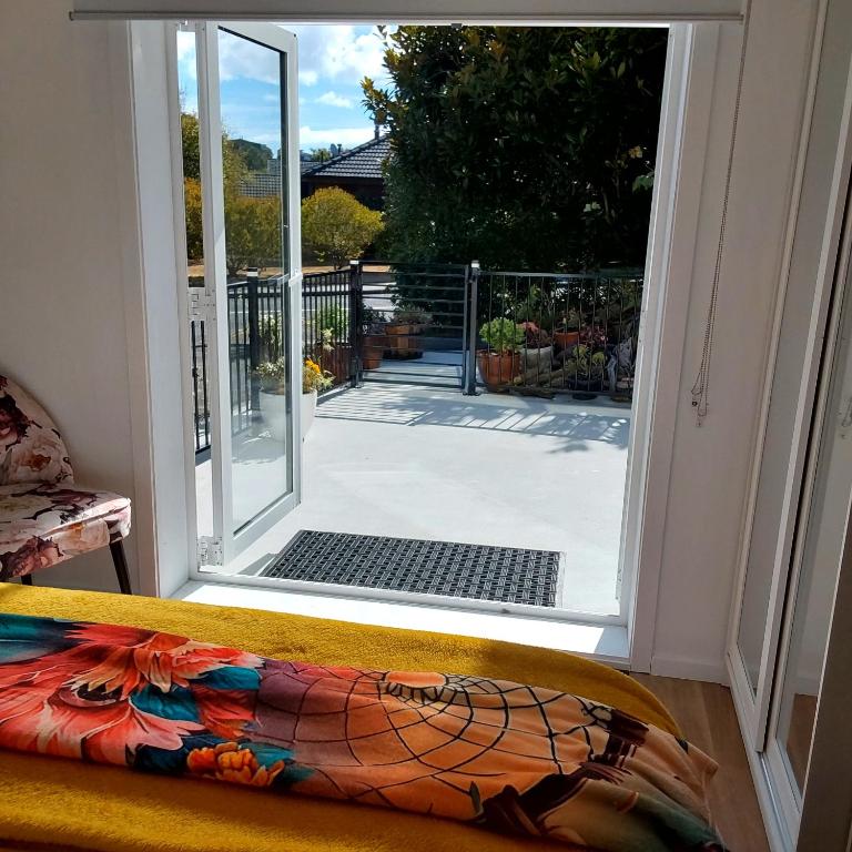 an open door with a view of a patio at The Hideaway in Raumati Beach