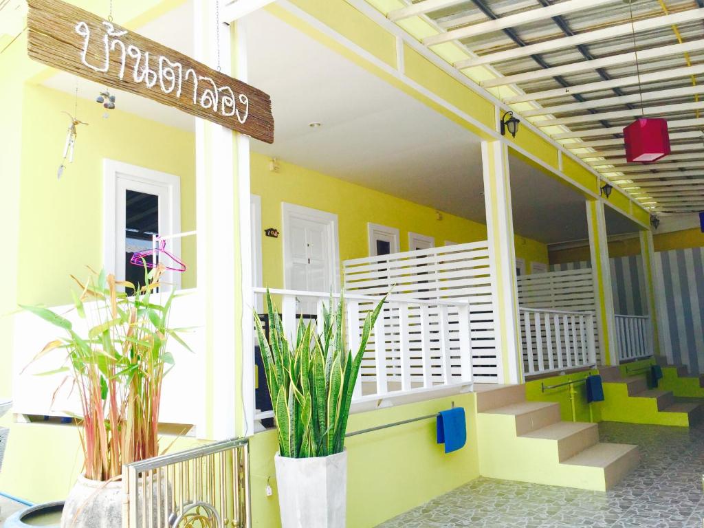 a front porch of a house with stairs and plants at Baan Ta Long Beach Koh Larn in Ko Larn