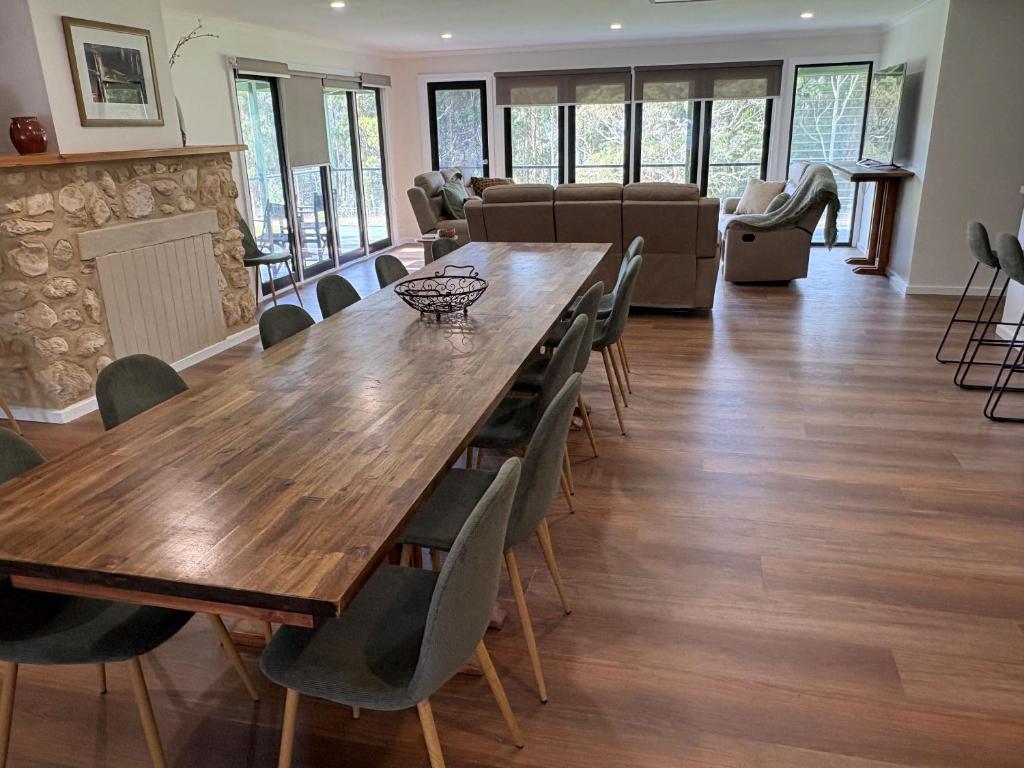 a dining room with a large wooden table and chairs at the Lodge farm house in Hindmarsh Valley