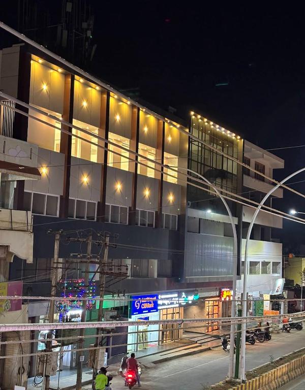 a building with lights on the side of a street at MRP Residency in Chitradurga