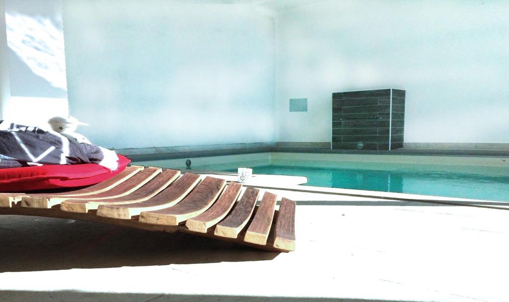 a person sitting on a bench next to a swimming pool at Casale del Vacanziere in Certaldo