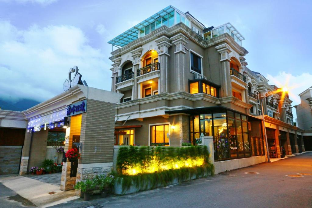 a large building with lights in front of it at Creekside No.22 B&B in Jiali