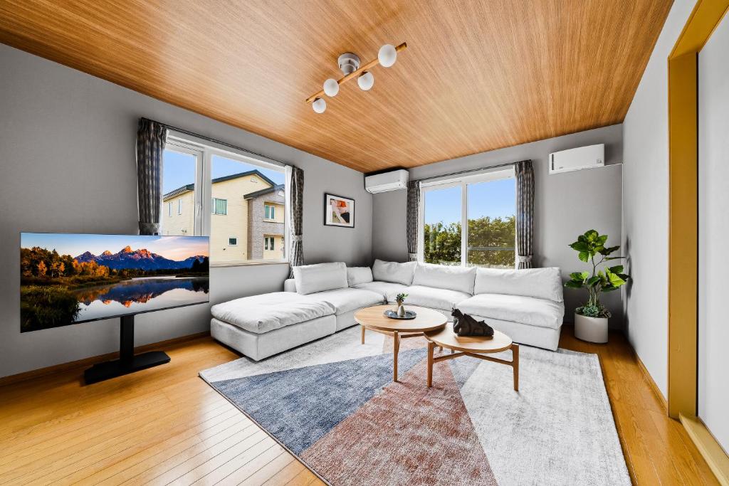 a living room with a white couch and a table at Silvale in Kami-furano
