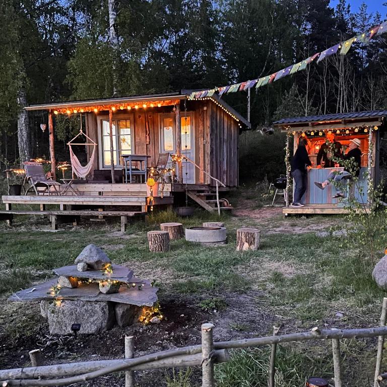 a woman standing in front of a tiny house at Vista Vibes Glamping in Grillby