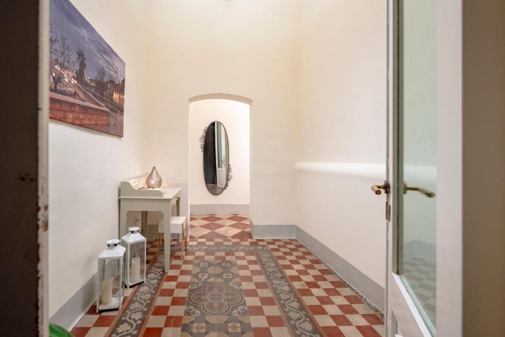 a hallway with a tile floor and a mirror at Garibaldi 54 in Bari
