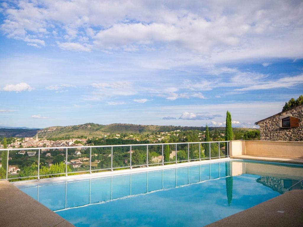 a swimming pool with a view of the mountains at gite villa ardeche joyeuse piscine in Joyeuse
