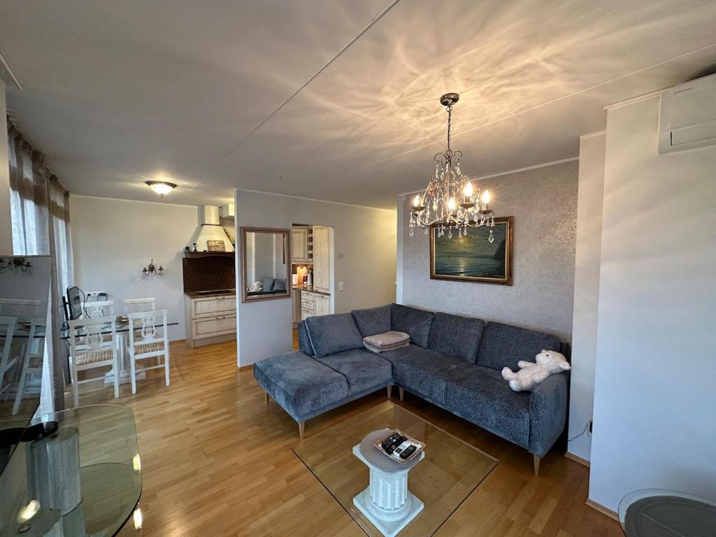 a living room with a blue couch and a table at Masti Apartment in Tallinn