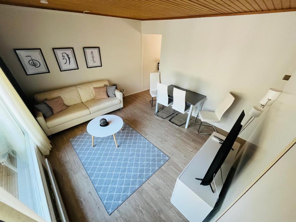 a living room with a couch and a table at The Zen Den Rokua in Utajärvi