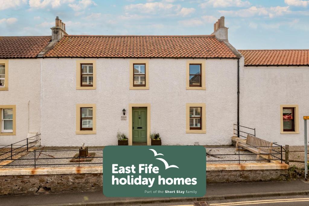 a house with a sign that reads east fire holiday homes at Driftwood - Pittenweem in Pittenweem