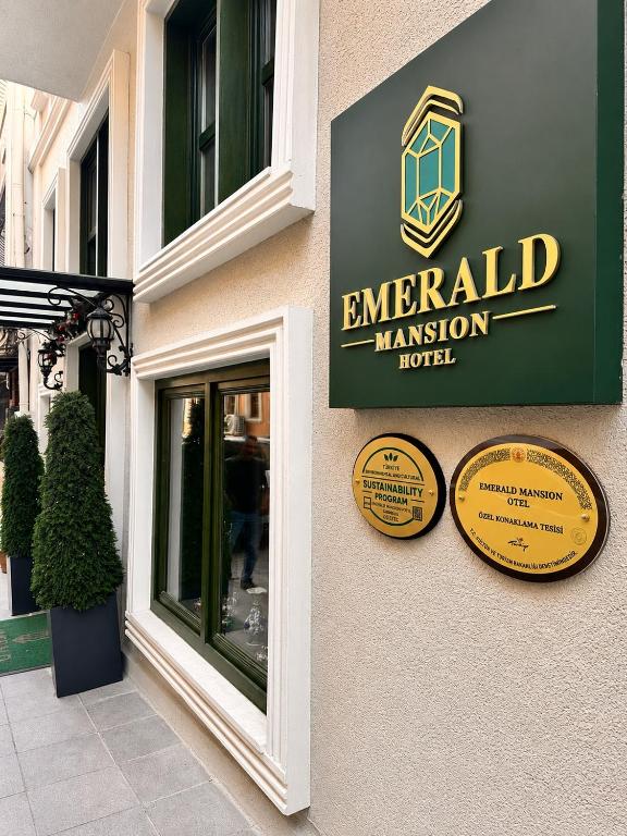a sign for an emerald mansion hotel on the side of a building at Emerald Mansion Hotel - Special Category in Istanbul