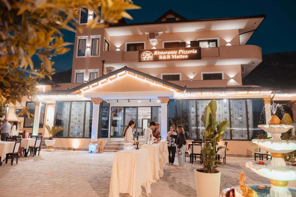 a group of people standing in front of a hotel at Matteo Garden & Restaurant in Vlorë