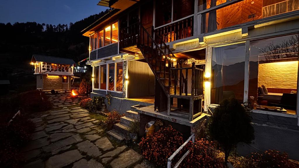 a house with a staircase on the side of it at night at Nirvana Trueliving in Nagar