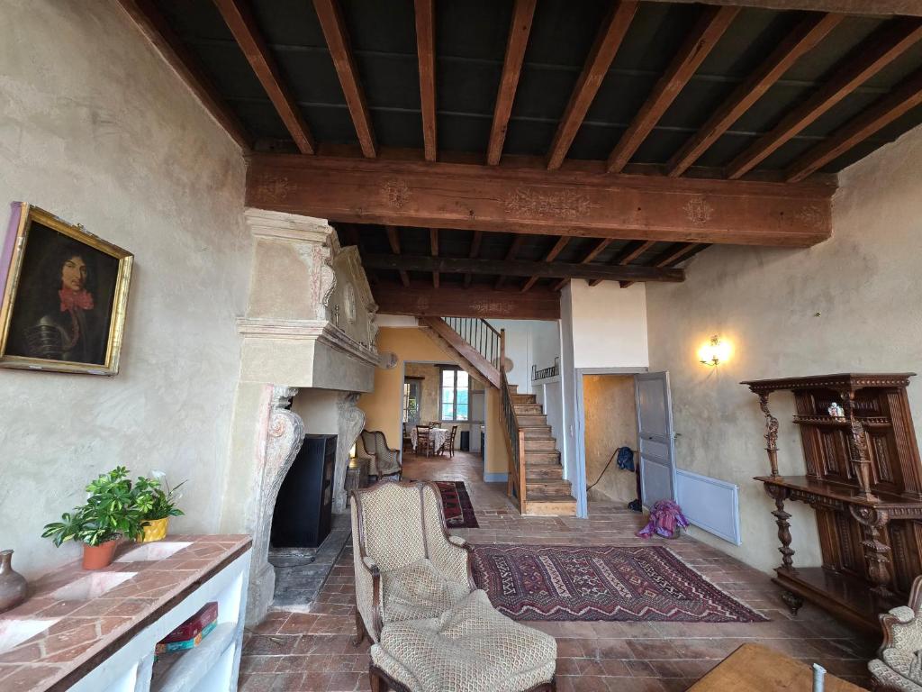 a living room with a staircase in a house at Maison centre historique in Lectoure