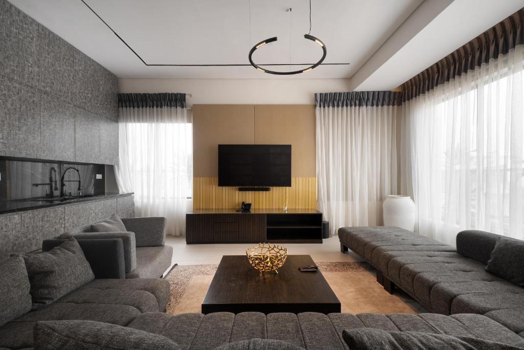 a living room with a couch and a tv at 108 Opebi Executive Apartments in Lagos