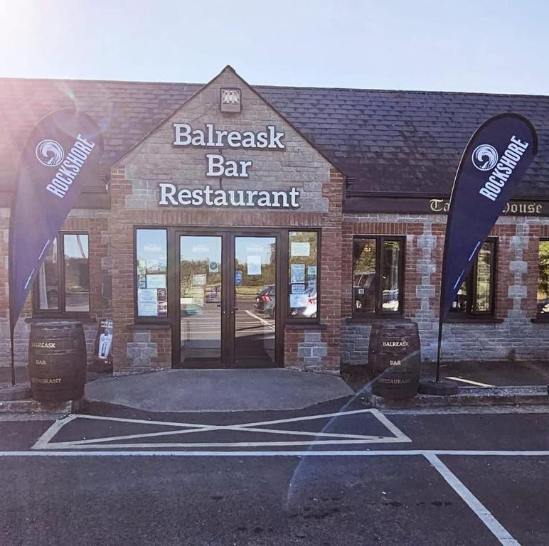 a bar restaurant with a sign in front of it at Balreask Bar, Restaurant & Guest Accommodation in Navan