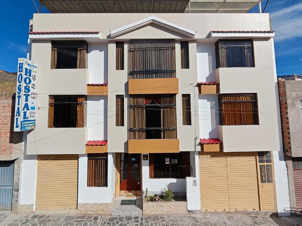 an image of a building with many windows at Hostal Amazonas in Chivay