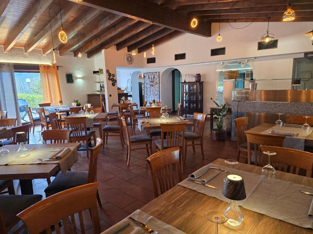 a restaurant filled with wooden tables and chairs at La Locanda del Gusto in Cadro
