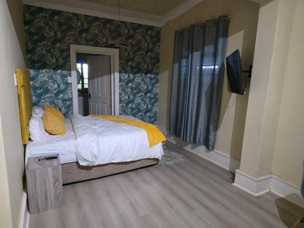 a bedroom with a bed and a television in it at Peaceful Accommodation in Durban