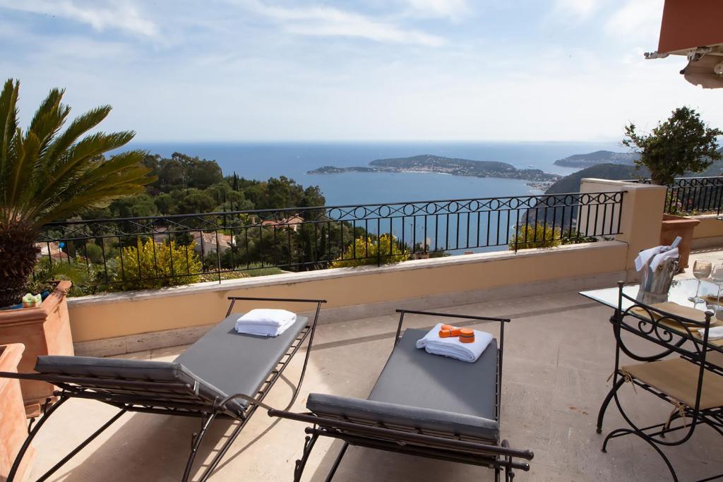 a balcony with chairs and a view of the ocean at Sunny Panoramic Balcony in Èze