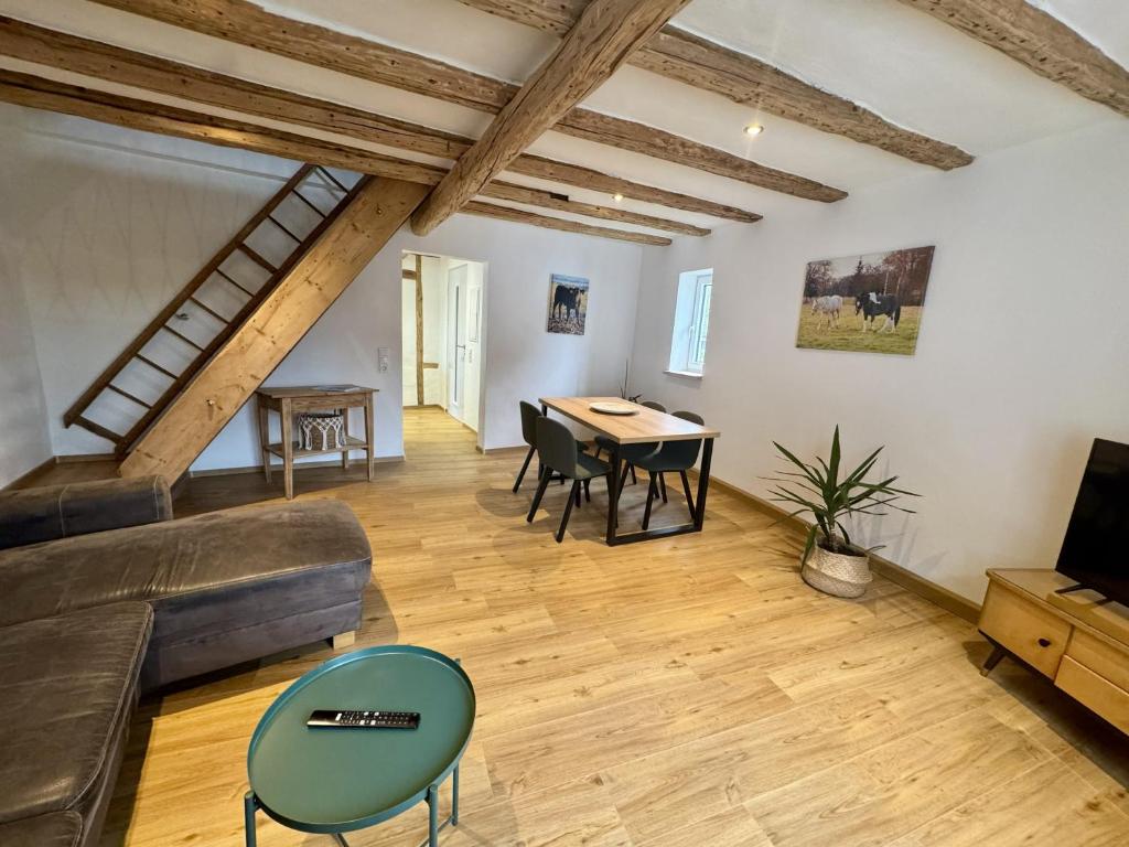 a living room with a couch and a table at Ferienscheune Rheingoldhof in Sankt Goar