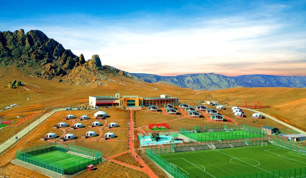 an aerial view of a parking lot with a tennis court at Red Rock Resort Mongolia in Yoliin Hural