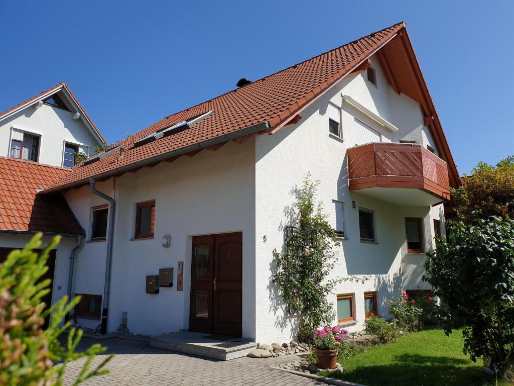 a white house with a red roof at Ferienwohnung Irene in Bad Saulgau