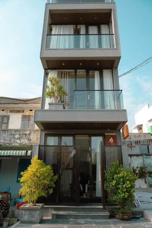 a house with glass doors and a balcony at ANNA Boutique Villa - Sea View in Phan Thiet