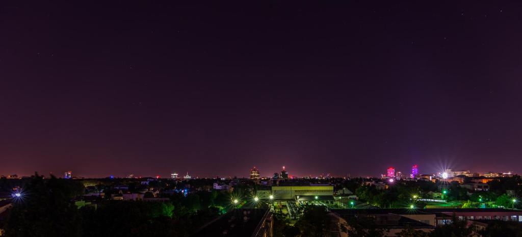 a view of a city at night with lights at Stone Gate Apartment #1 in Bucharest