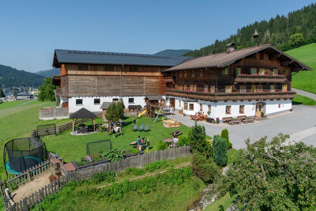 an aerial view of a large wooden building with a yard at Nöglhof in Radstadt