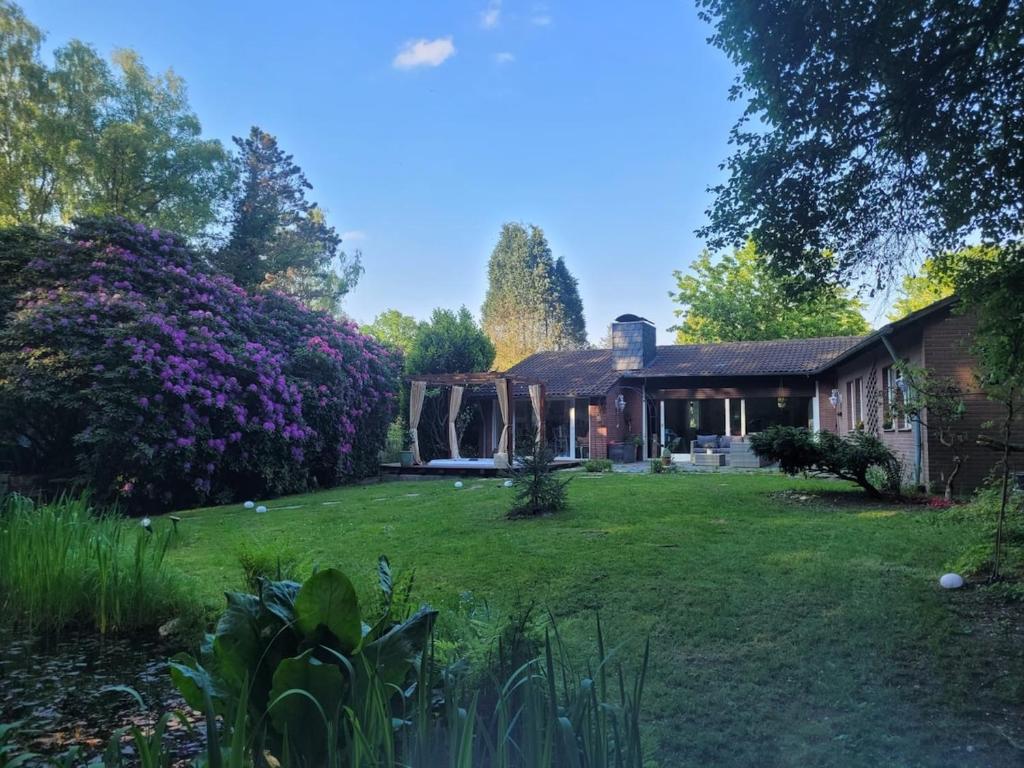 a house with a large yard with a house at Natur Spa Haus in Niederkrüchten