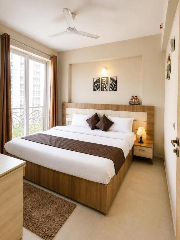 a bedroom with a large bed with a large window at Hidden house stay in Mathura