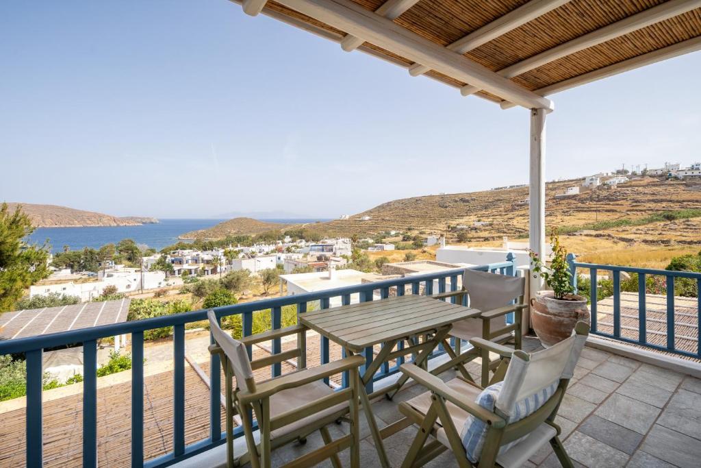 a balcony with a table and chairs and the ocean at Almira 2 in Livadakia