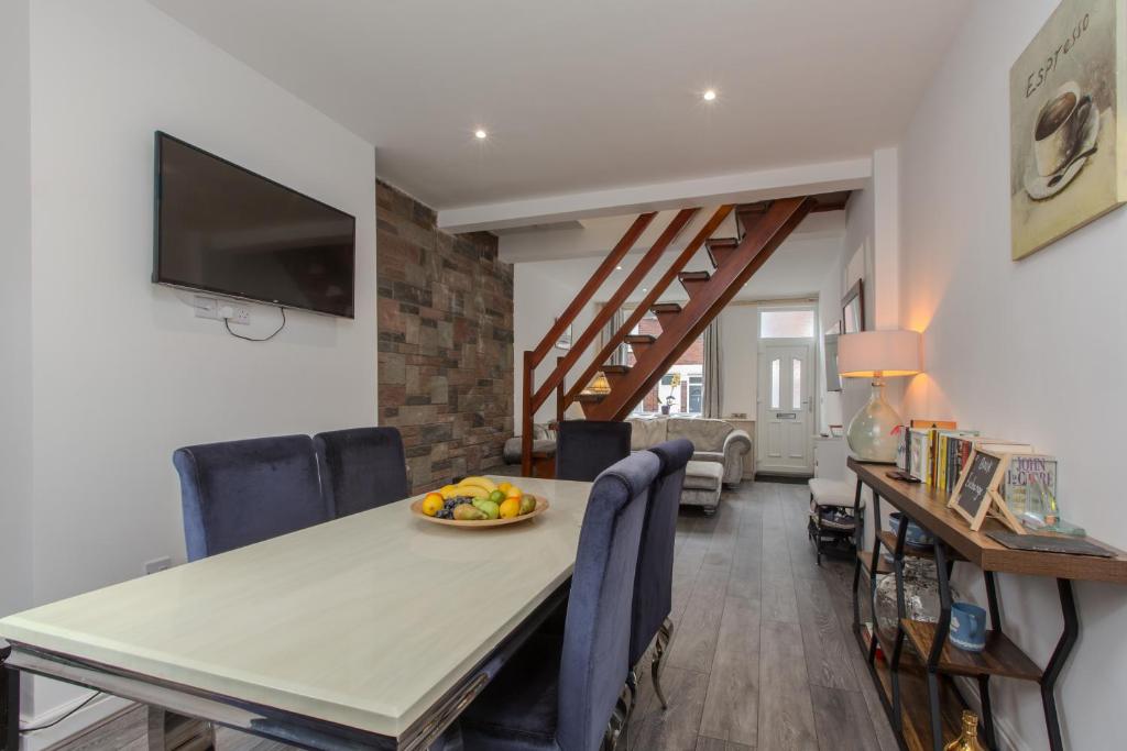 a dining room with a table with a bowl of fruit on it at High End Central Location 2 Bedroom in Stoke on Trent