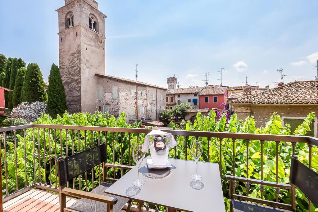 a white table and chairs on a balcony at Hotel Corte Regina in Sirmione