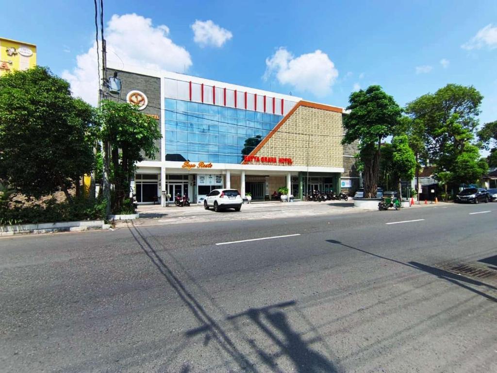 an empty street in front of a building at Satya Graha Hotel Yogyakarta in Yogyakarta