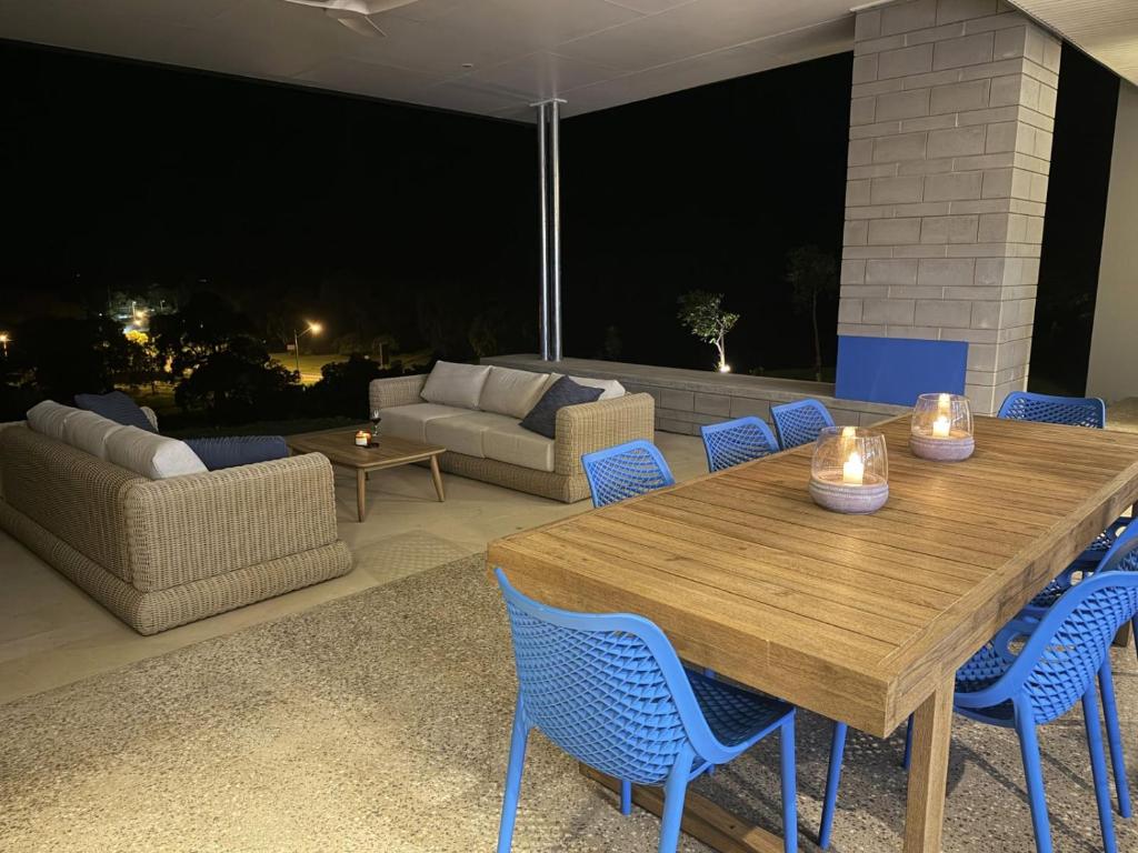 a wooden table and chairs on a patio at night at Cooktown Getaway in Cooktown