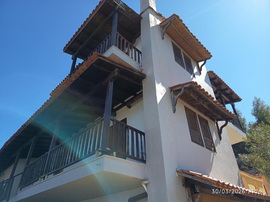 a white building with balconies on the side of it at Best view in Polychrono - Families Only in Polychrono