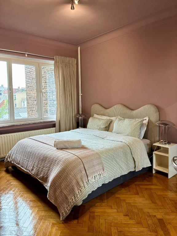 a bedroom with a large bed and a window at Spacious Home in Brussels in Brussels