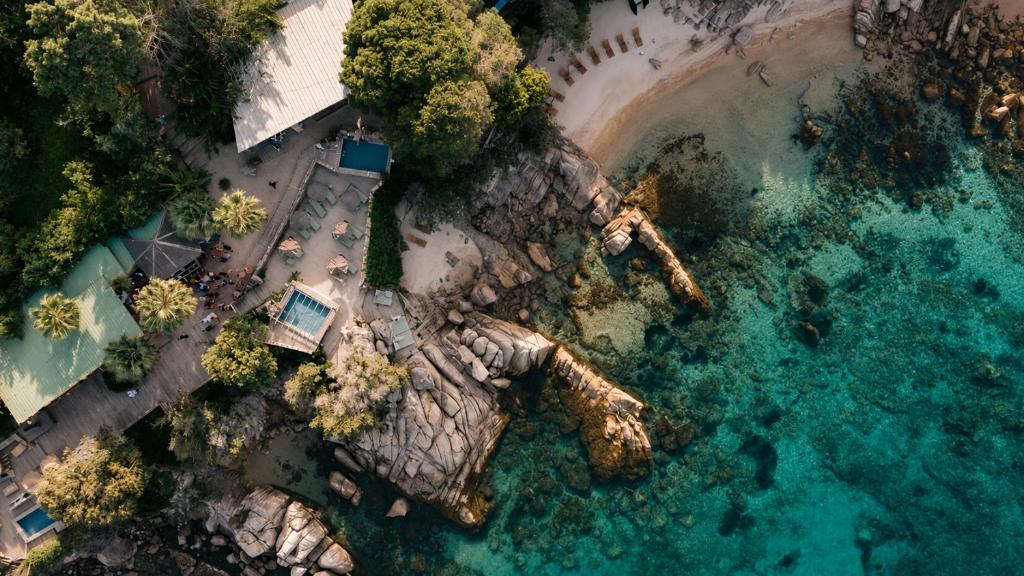 an aerial view of a rocky island in the ocean at Lagnonu in Verghia