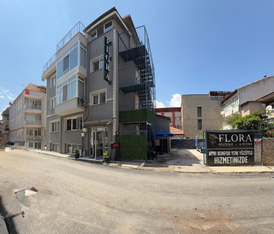 a building on the side of a street with a sign at Flora Otel 16 rooms in Edirne