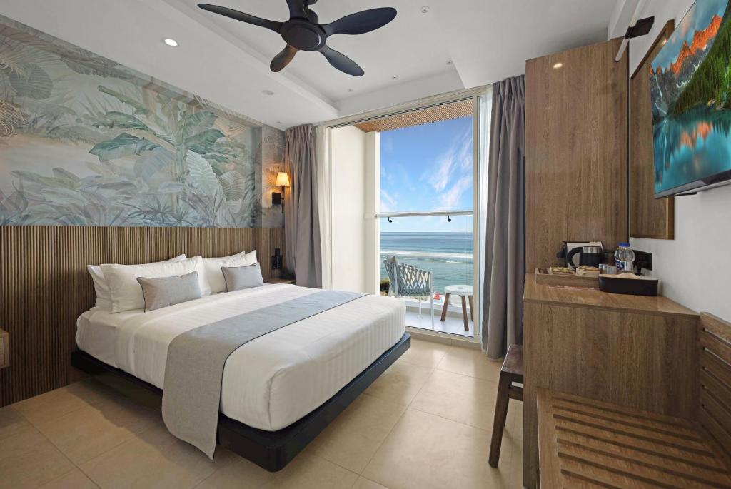 a bedroom with a bed and a view of the ocean at Hotel Amber Seaside in Hulhumale