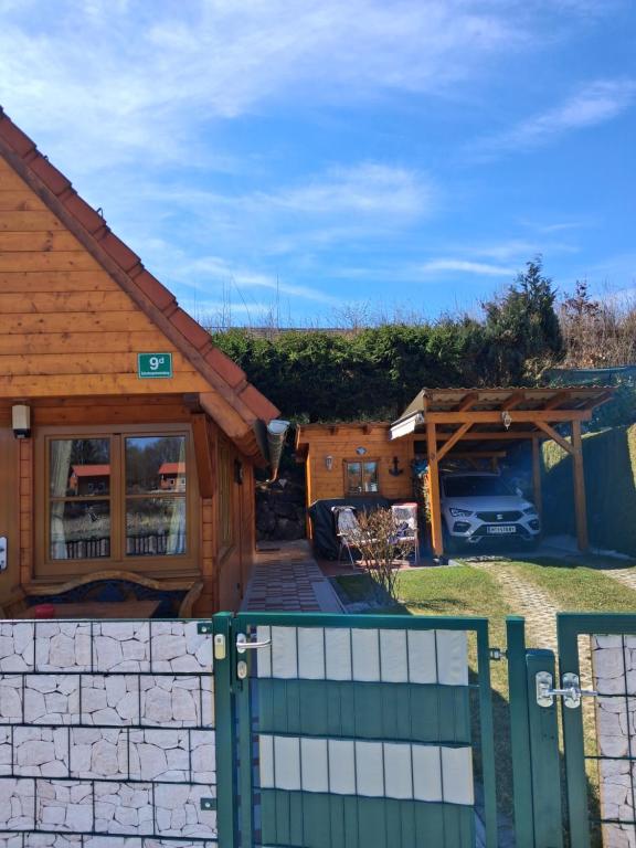 a wooden house with a gate and a fence at Haus Marlies in Spielberg