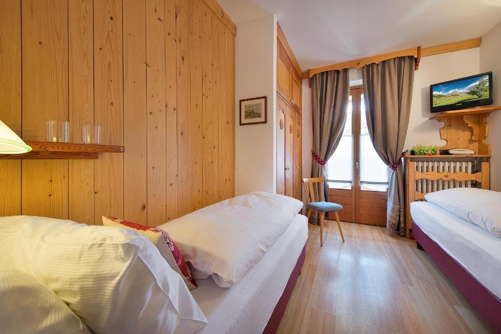 Postel nebo postele na pokoji v ubytování Hotel Posta