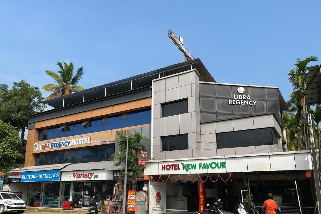 a building on the corner of a street at LlBRA REGENCY in Guruvāyūr