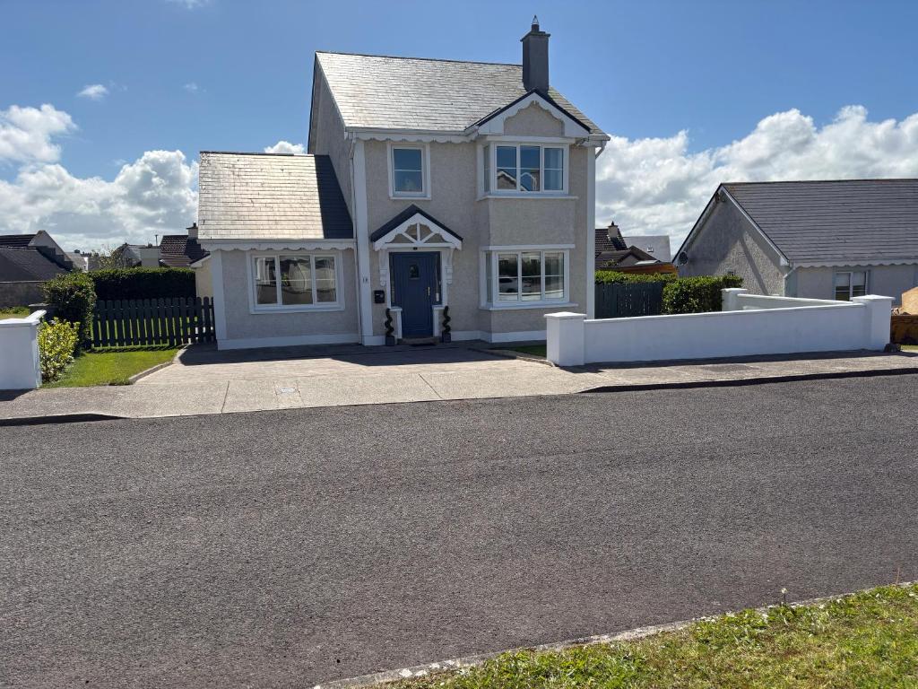 a white house with a driveway in front of it at Seaview in Enniscrone
